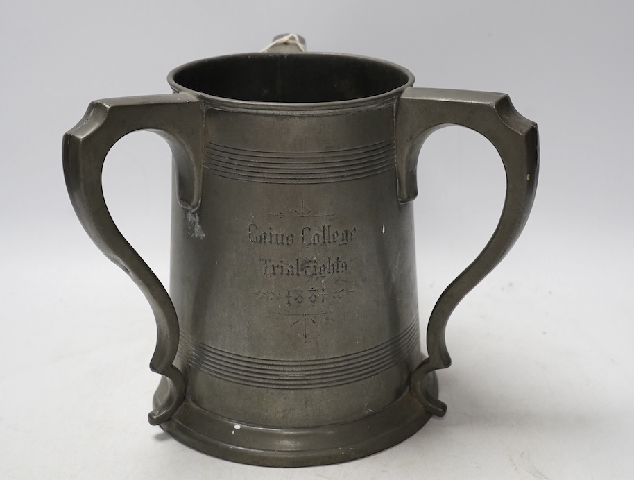 A 19th century pewter three handled rowing trophy from Caius College, 19cm. Condition - fair